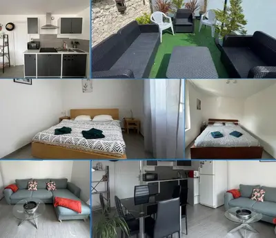 Cuisine ou kitchenette dans l'établissement Les mouettes Apt duplex indépendant dans maison spacieux petite vue sur mer des chambres belle terrasse aménagée en hauteur près Omaha Beach et Bayeux 800 m plage et 300 m superette