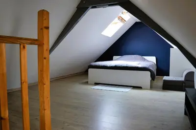 Un ou plusieurs lits dans un hébergement de l'établissement Halte Lutine - Maison chaleureuse en pierres