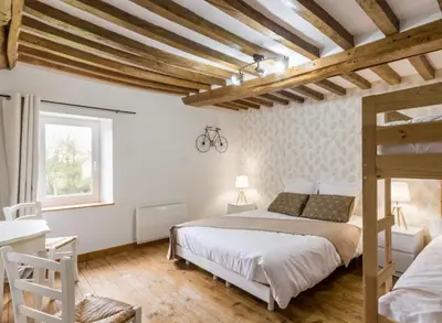 Un ou plusieurs lits dans un hébergement de l'établissement L'Îlot Pomme Cottage