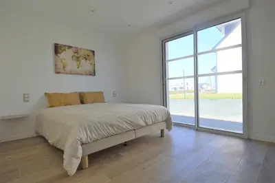 Un ou plusieurs lits dans un hébergement de l'établissement Saint Côme Beach House