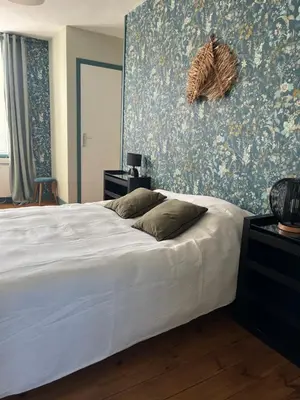 Un ou plusieurs lits dans un hébergement de l'établissement Maison de vacances vaux sur seulles