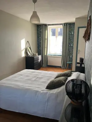 Un ou plusieurs lits dans un hébergement de l'établissement Maison de vacances vaux sur seulles